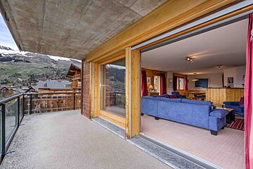A living room with a blue couch and red curtains