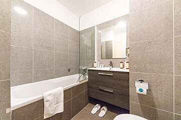 A bathroom with a bathtub a sink and a toilet