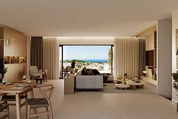A modern, neutral-toned living and dining room with a large window offering panoramic views of a lush hillside and distant sea.