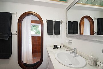 A bathroom with a sink and a large mirror