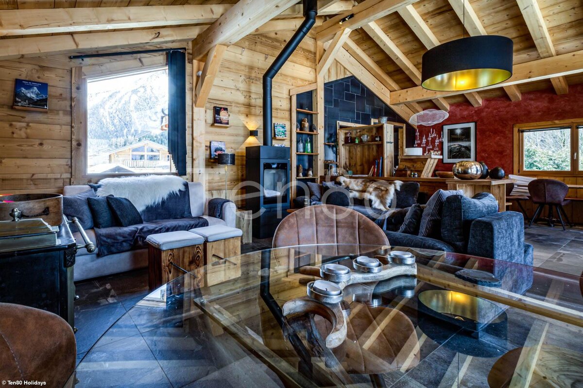 A living room with a glass table and a couch