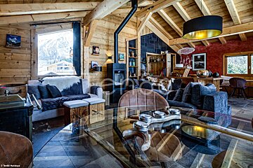 A living room with a glass table and a couch