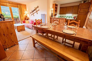 A wooden table with plates and glasses on it
