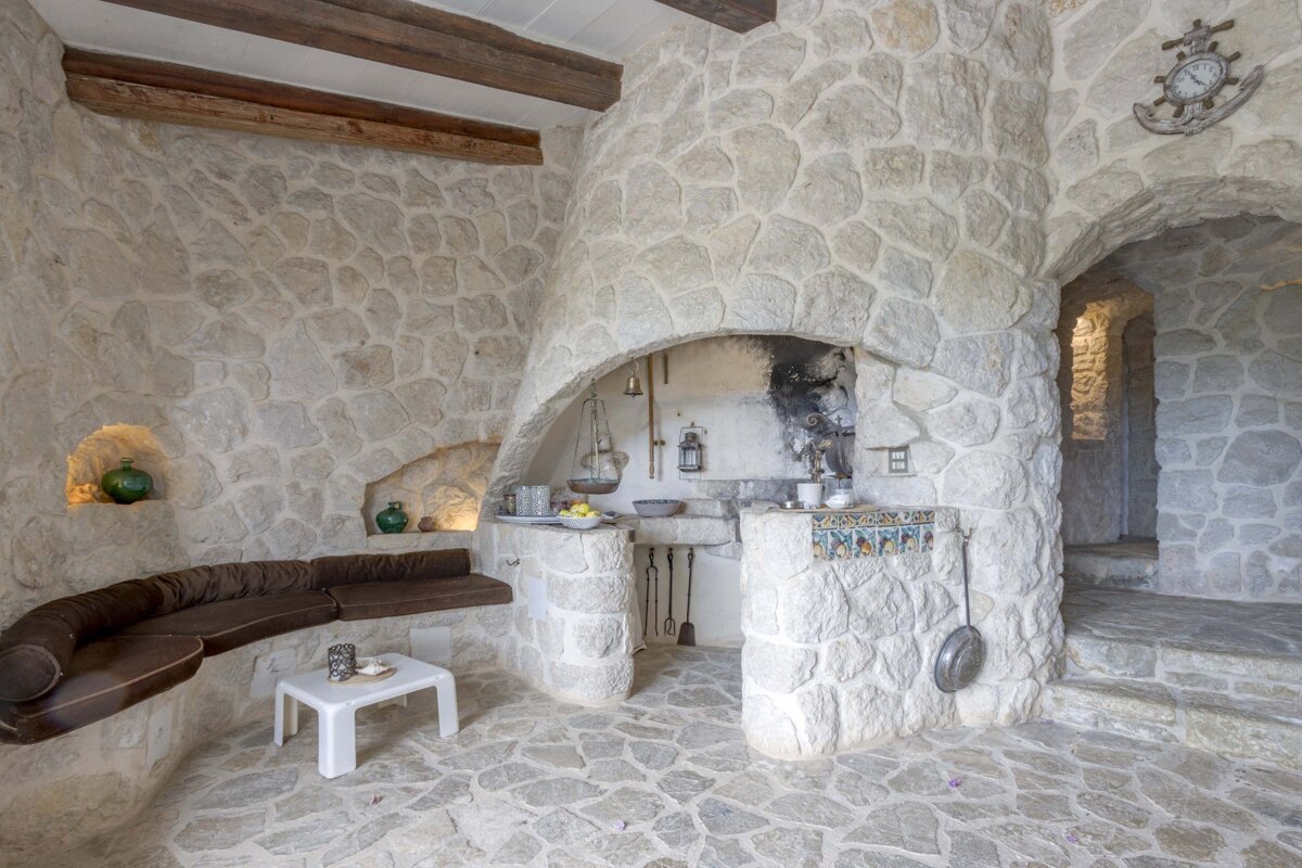 A room with a stone wall and a clock on the wall