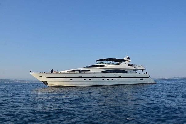 A large white yacht is floating in the ocean