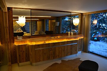 A bathroom with a wooden counter top and a large mirror