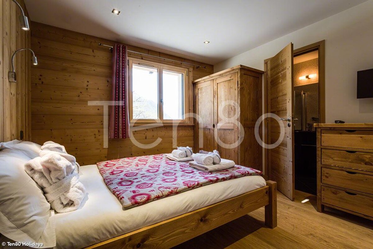 A bedroom with a bed and a sign that says terra80 holidays