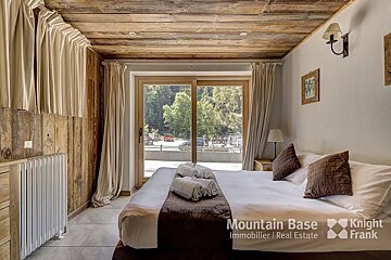 A bedroom with a bed and the words mountain base on the wall