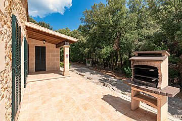 A patio with a grill and a sign that says ' a ' on it
