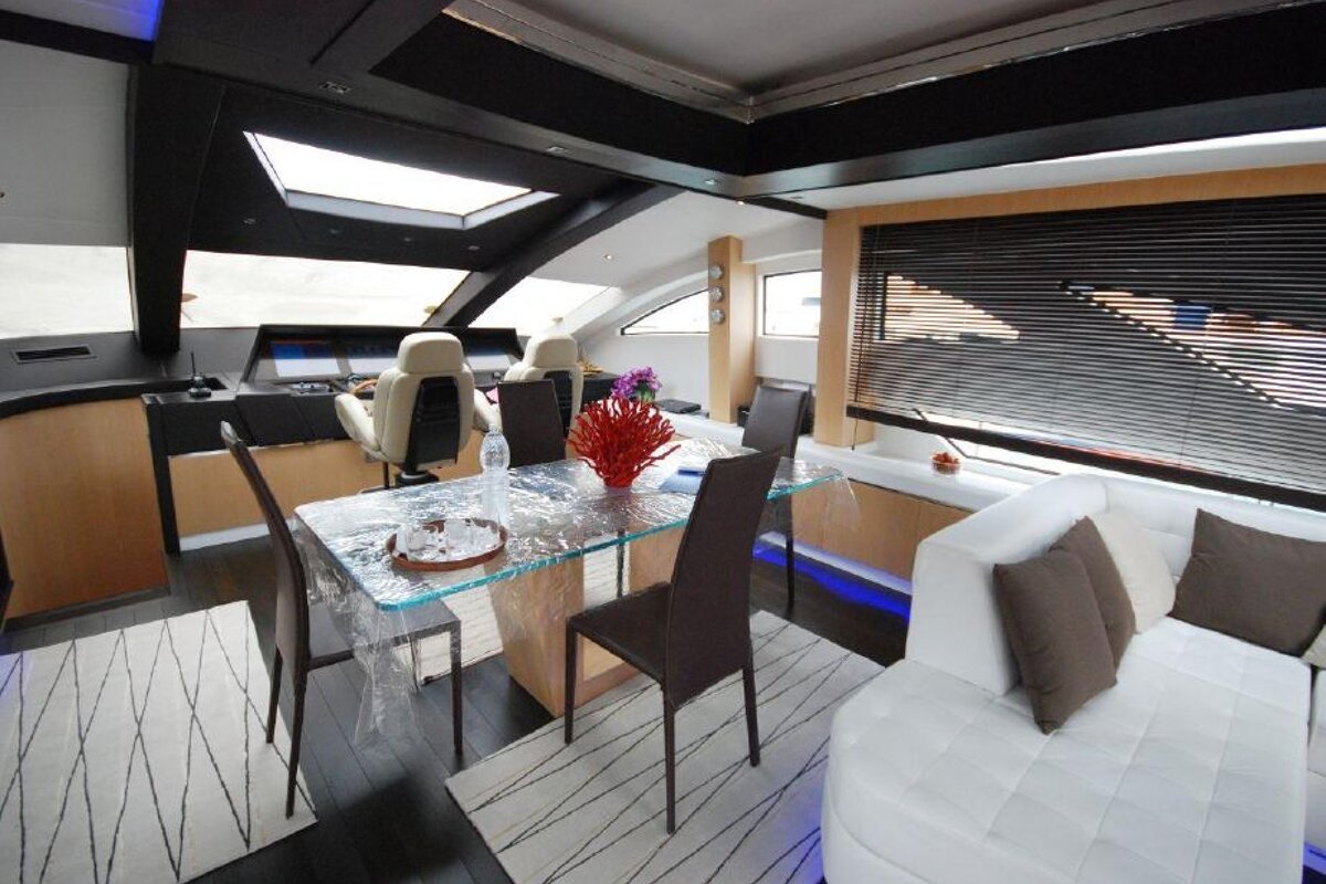 A living room with a glass table and chairs