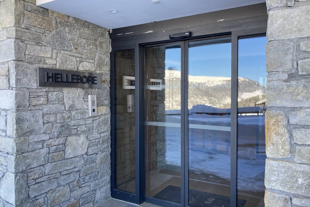 A sliding glass door with a sign that says hellebore