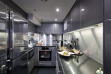 A kitchen with stainless steel appliances and black counter tops