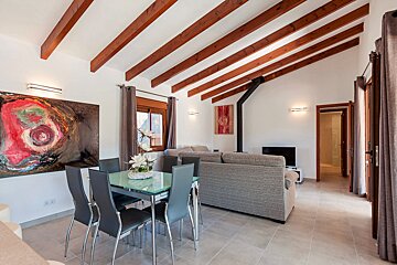 A living room with a dining table and chairs