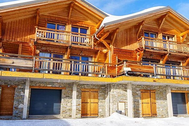 A large wooden house with a sign on the front that says 