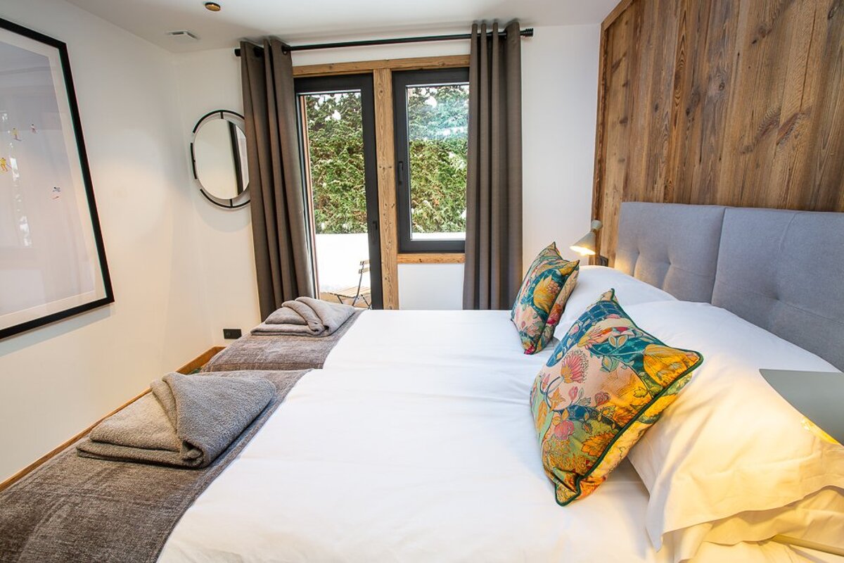 A bedroom with a large bed and a window