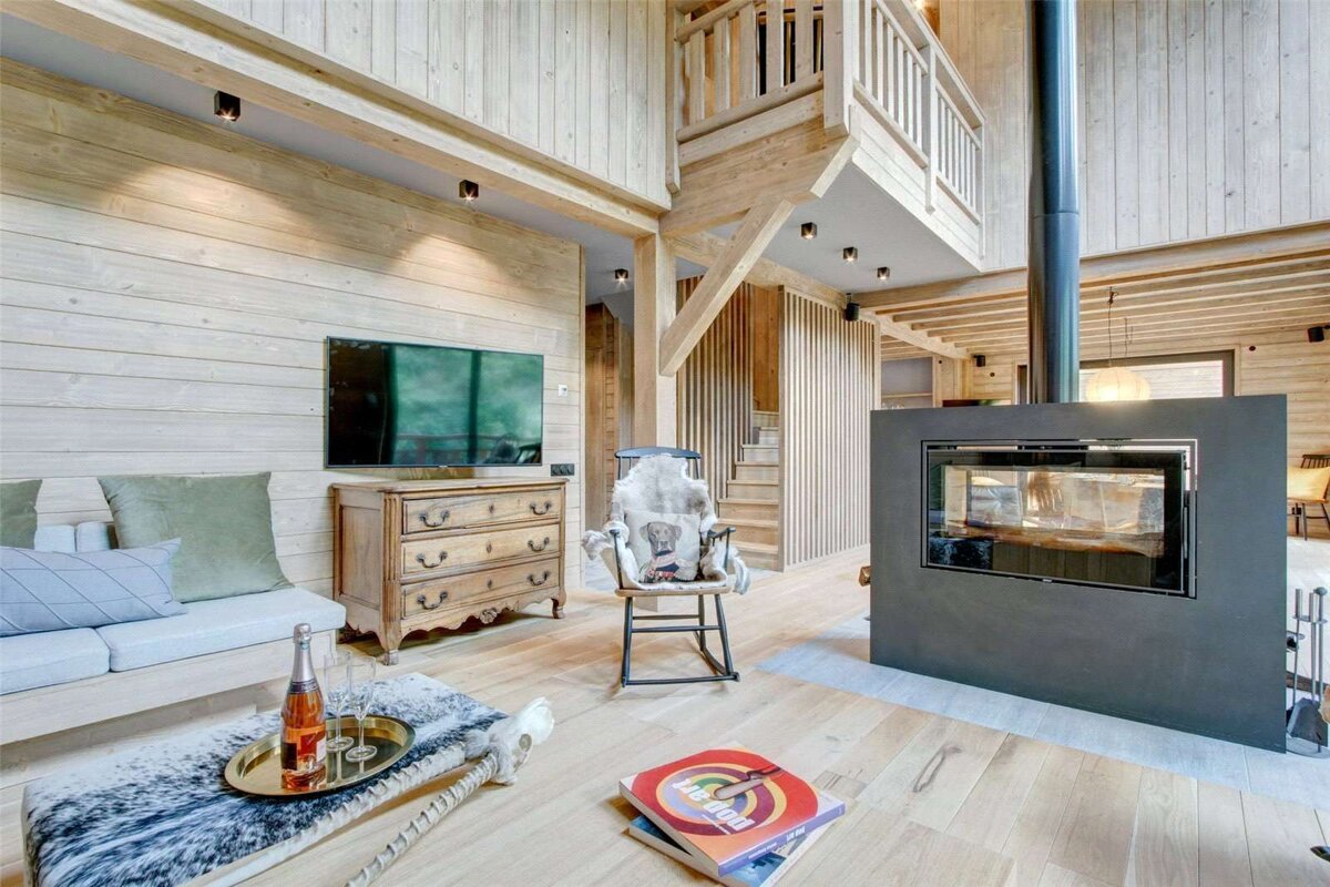 A living room with a fireplace and a rocking chair