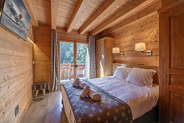 A bunk bed in a wooden room with snowflakes on the wall