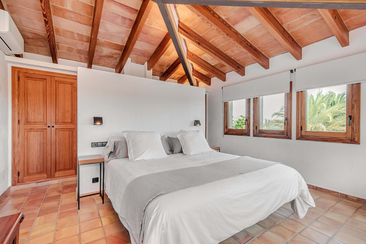 A bedroom with a canopy bed and a wooden ceiling