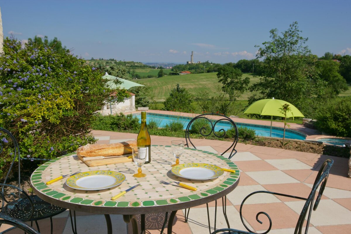 A table with plates and a bottle of wine on it
