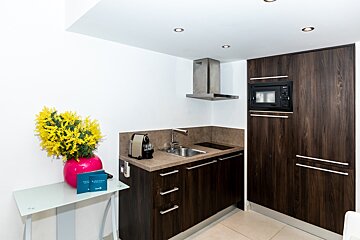 A small kitchen with a microwave and a sink