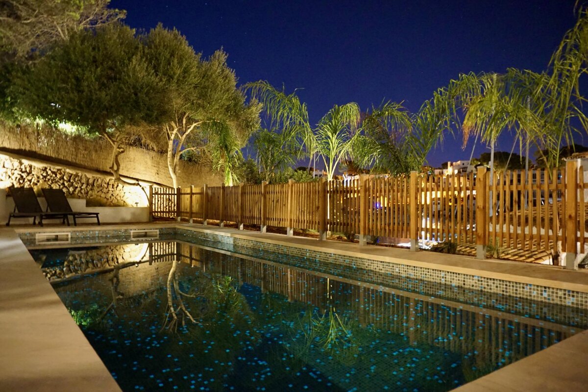 A swimming pool with a wooden fence around it