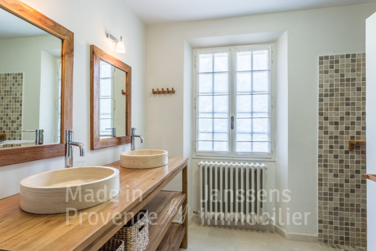 A bathroom with two sinks and two mirrors made in provence