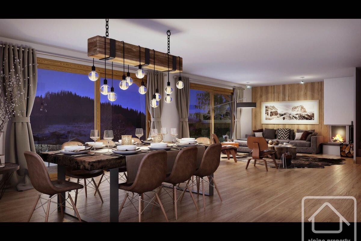 Cozy, modern alpine dining and living room. Large windows reveal a dark mountain vista. Features an industrial chandelier, fireplace, and chic seating.