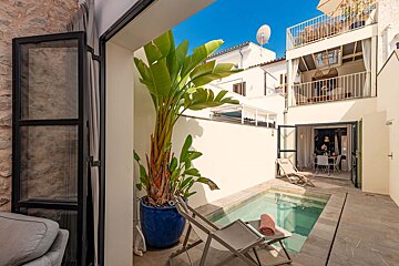 A small swimming pool in the backyard of a house