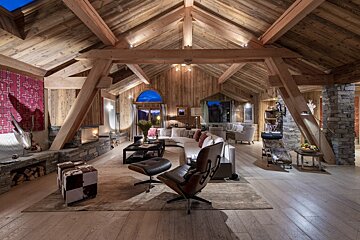 A living room with wooden beams and a couch