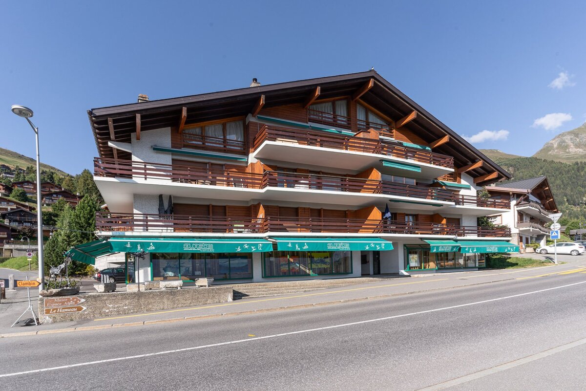 A building with a green awning that says timo on it