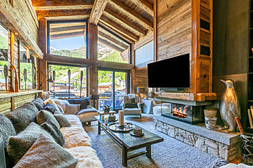 A living room with a fireplace and a flat screen tv