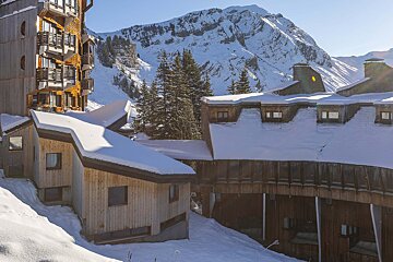 A snowy building with a mountain in the background