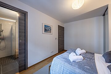 A bedroom with a bed and a picture on the wall