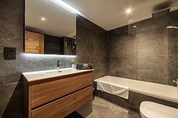 A bathroom with a sink a toilet and a bathtub