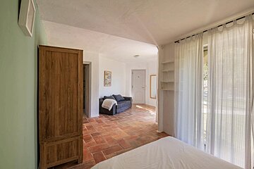 A bedroom with a couch and a sign that says