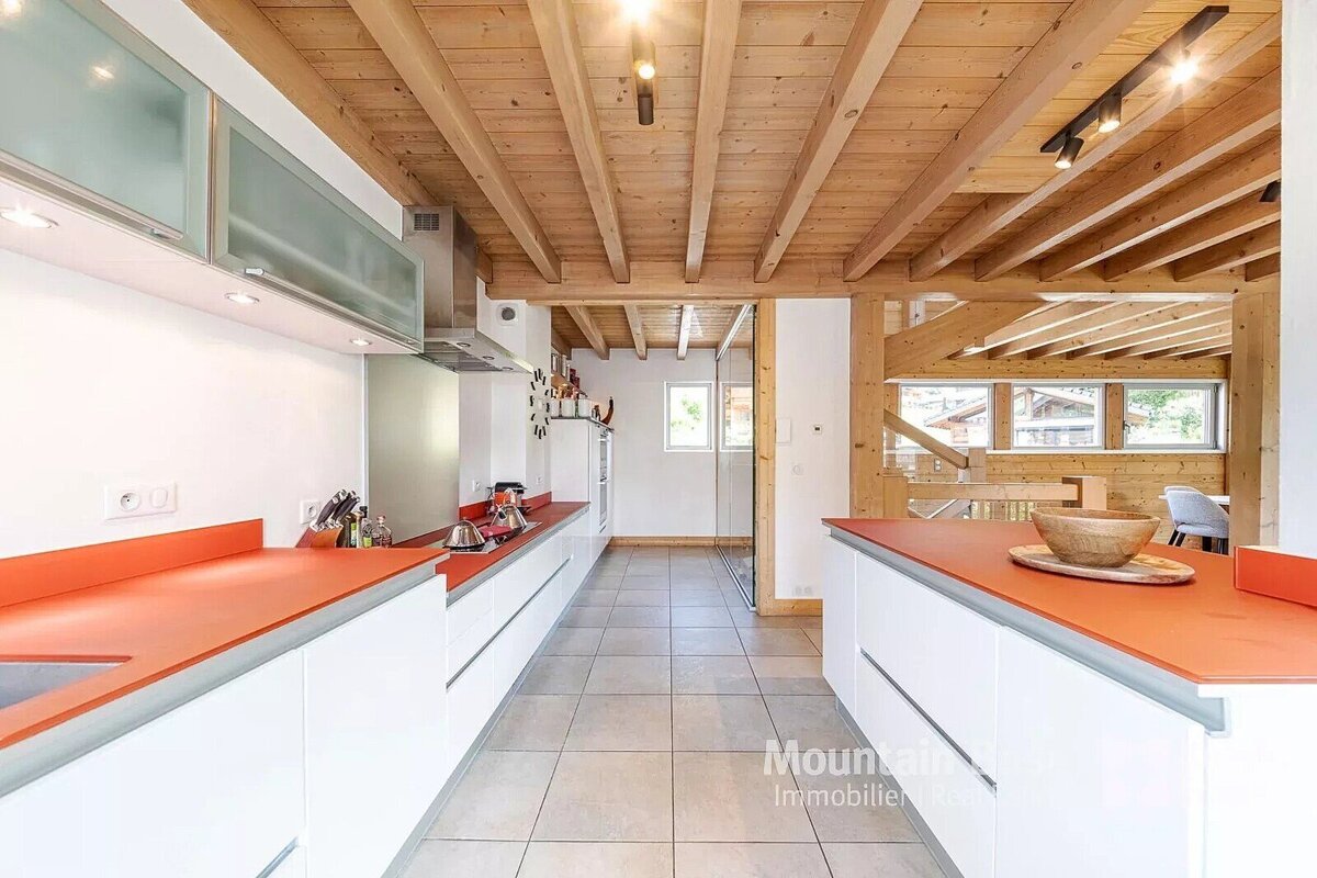 A kitchen with a wooden ceiling and the word mountain on the bottom