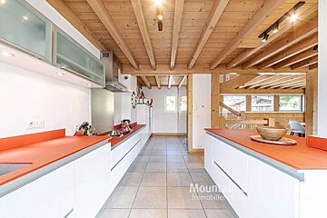 A kitchen with a wooden ceiling and the word mountain on the bottom