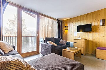 A living room with a couch and a flat screen tv