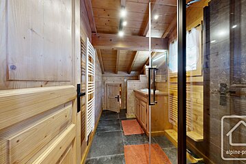 A bathroom with a glass door and a sign that says alpine-pro