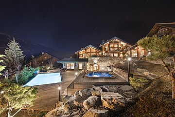 A large house with a swimming pool in front of it