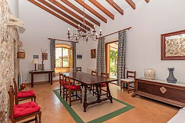 A dining room with a table and chairs and a chandelier