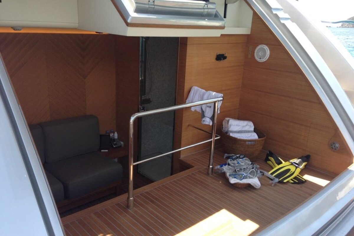 A boat with a chair and a basket of towels
