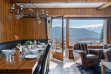 A dining room with a view of the mountains
