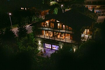 An aerial view of a large house at night