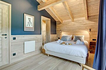 A bedroom with a bed and a poster on the wall that says 