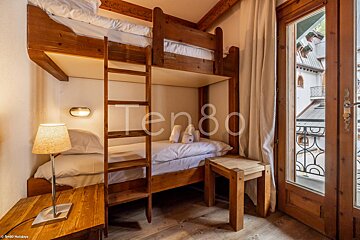 A bunk bed with the number ten80 on the wall