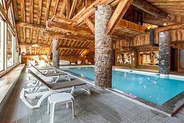 A large indoor swimming pool in a wooden building