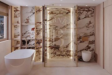 Luxurious modern bathroom with marble walls, a freestanding tub, and a glass walk-in shower, illuminated by subtle lighting.