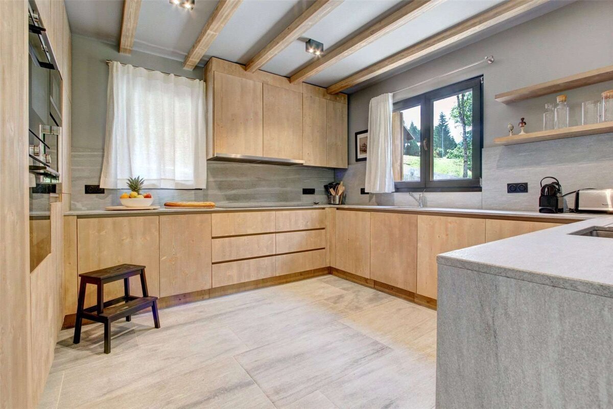 A kitchen with wooden cabinets and white counter tops