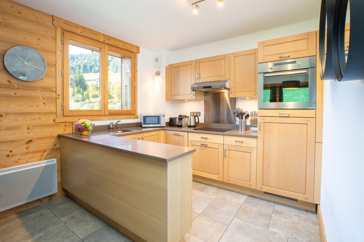 A kitchen with wooden cabinets and stainless steel appliances
